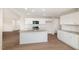 Open-concept kitchen with an island, granite countertops, stainless steel appliances, and seamless living room integration at 210 Maxwell Farm Ln, Selma, NC 27576