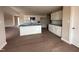Spacious open-concept kitchen featuring white cabinetry, a center island, and modern fixtures, perfect for entertaining at 210 Maxwell Farm Ln, Selma, NC 27576