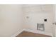 Functional laundry room with white walls, hookups, and a clean, minimalist design for efficient chore management at 210 Maxwell Farm Ln, Selma, NC 27576
