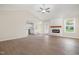 Inviting living room featuring hardwood floors, fireplace, ceiling fan, and open concept kitchen, perfect for gatherings at 210 Maxwell Farm Ln, Selma, NC 27576