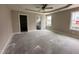 Comfortable main bedroom with tray ceiling and ensuite bathroom, ready to be transformed into a personal oasis at 210 Maxwell Farm Ln, Selma, NC 27576