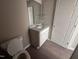 Compact bathroom featuring granite countertops, tile flooring, and essential fixtures at 212 Tuscany Cir, Princeton, NC 27569