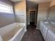 Bathroom features a soaking tub, separate shower, modern vanity, and granite countertop at 212 Tuscany Cir, Princeton, NC 27569