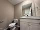 Cozy half bath with granite countertop vanity and modern fixtures at 212 Tuscany Cir, Princeton, NC 27569