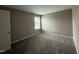 Neutral bedroom featuring plush carpet, a window for natural light, and a clean, modern aesthetic at 212 Tuscany Cir, Princeton, NC 27569