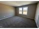 Comfortable bedroom with plush carpet, natural light, and neutral walls, perfect for relaxation at 212 Tuscany Cir, Princeton, NC 27569