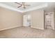 Spacious bedroom features neutral carpeting and an ensuite bathroom at 212 Tuscany Cir, Princeton, NC 27569