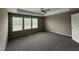 Spacious bedroom featuring large windows and carpeted floors at 212 Tuscany Cir, Princeton, NC 27569