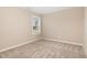 Bedroom featuring plush carpet and a bright window for natural light at 212 Tuscany Cir, Princeton, NC 27569