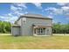 Green two-story house with backyard, concrete patio, and lush green lawn on a sunny day at 212 Tuscany Cir, Princeton, NC 27569