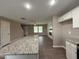 Modern kitchen featuring an island with granite countertops and open view to the living area at 212 Tuscany Cir, Princeton, NC 27569