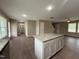 Open kitchen featuring island with granite counters and stainless steel appliances, open to living room at 212 Tuscany Cir, Princeton, NC 27569