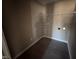 Practical laundry room featuring washer/dryer hookups, wire shelving, and durable flooring at 212 Tuscany Cir, Princeton, NC 27569