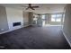 Open concept living room with fireplace and modern flooring, seamlessly connected to the kitchen at 212 Tuscany Cir, Princeton, NC 27569