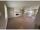 Spacious living room featuring wood floors, a fireplace, and open layout to the kitchen at 212 Tuscany Cir, Princeton, NC 27569