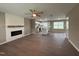 Open-concept living room with modern fireplace and wood flooring, connecting to the kitchen at 212 Tuscany Cir, Princeton, NC 27569