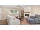 Bright living room featuring neutral walls, wood flooring, a fireplace, and contemporary furnishings at 212 Tuscany Cir, Princeton, NC 27569