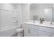 Modern bathroom featuring double sinks, white cabinets, and a shower-tub combo at 2153 Monk Dr, Haw River, NC 27258