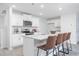 Modern kitchen with white cabinets, stainless steel appliances, granite countertops, and an island with bar seating at 2153 Monk Dr, Haw River, NC 27258