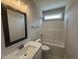 Bathroom featuring single sink vanity, framed mirror, tub-shower combo, and neutral finishes at 221 Tee Dr, Selma, NC 27576