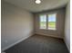 Neutral bedroom with gray carpet, double window with natural light and standard closet at 221 Tee Dr, Selma, NC 27576