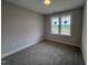 Bedroom with neutral paint, carpet flooring, and a large window at 221 Tee Dr, Selma, NC 27576