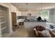 Open kitchen featuring a center island, stainless steel appliances, and white cabinets at 221 Tee Dr, Selma, NC 27576