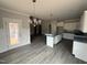 Open kitchen with granite countertops, white cabinets, and stainless steel appliances at 221 Tee Dr, Selma, NC 27576