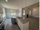 Modern kitchen with granite countertops, stainless steel appliances, and a center island at 221 Tee Dr, Selma, NC 27576