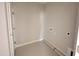 Functional laundry room with tiled floors and hook ups for washing machine and dryer at 221 Tee Dr, Selma, NC 27576