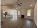 Open concept living room and kitchen with hardwood floors, fireplace and large windows at 221 Tee Dr, Selma, NC 27576