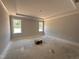 Spacious main bedroom with tray ceiling and windows bringing in lots of light at 221 Tee Dr, Selma, NC 27576