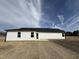 Exterior back view of home with siding, black roof, and a large yard at 225 Phil Jack Rd, Dunn, NC 28334