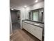 Bathroom with a double sink vanity, granite countertops, and a walk-in closet at 225 Phil Jack Rd, Dunn, NC 28334