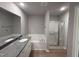 Bright bathroom with a tub, shower, granite countertop and wooden floors at 225 Phil Jack Rd, Dunn, NC 28334