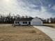 Charming single-story home featuring a classic white facade and a two-car garage at 225 Phil Jack Rd, Dunn, NC 28334