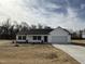 Charming single-story home featuring a classic white facade and a two-car garage at 225 Phil Jack Rd, Dunn, NC 28334