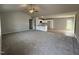 Bright living room featuring a gray carpet and an open layout to the kitchen at 225 Phil Jack Rd, Dunn, NC 28334