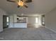Bright living room featuring a gray carpet and an open layout to the kitchen at 225 Phil Jack Rd, Dunn, NC 28334