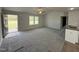 Bright living room with plush gray carpet and a ceiling fan at 225 Phil Jack Rd, Dunn, NC 28334