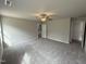 Spacious main bedroom featuring plush gray carpet, a ceiling fan, and natural light at 225 Phil Jack Rd, Dunn, NC 28334