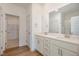 Bathroom with double sink vanity, quartz countertop, and large mirror at 231 Trescott St, Smithfield, NC 27577