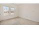 Bright bedroom with neutral carpeting and two large windows providing natural light at 231 Trescott St, Smithfield, NC 27577
