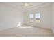 Bright, neutral bedroom with two windows, carpet, and ceiling fan at 231 Trescott St, Smithfield, NC 27577