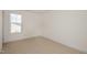 Bright bedroom with neutral carpeting and a large window providing natural light at 231 Trescott St, Smithfield, NC 27577