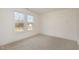 Bright bedroom with neutral carpeting and two large windows providing natural light at 231 Trescott St, Smithfield, NC 27577