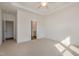 Spacious bedroom with a tray ceiling, ceiling fan, carpet flooring, and white walls at 231 Trescott St, Smithfield, NC 27577