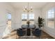 Virtually staged dining room with modern table, chairs, chandelier, and a plant at 231 Trescott St, Smithfield, NC 27577
