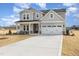 Beautifully landscaped two-story home with attached two-car garage and a wide driveway at 231 Trescott St, Smithfield, NC 27577
