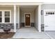 Covered front porch with stylish columns and stone accents enhance this beautiful home at 231 Trescott St, Smithfield, NC 27577